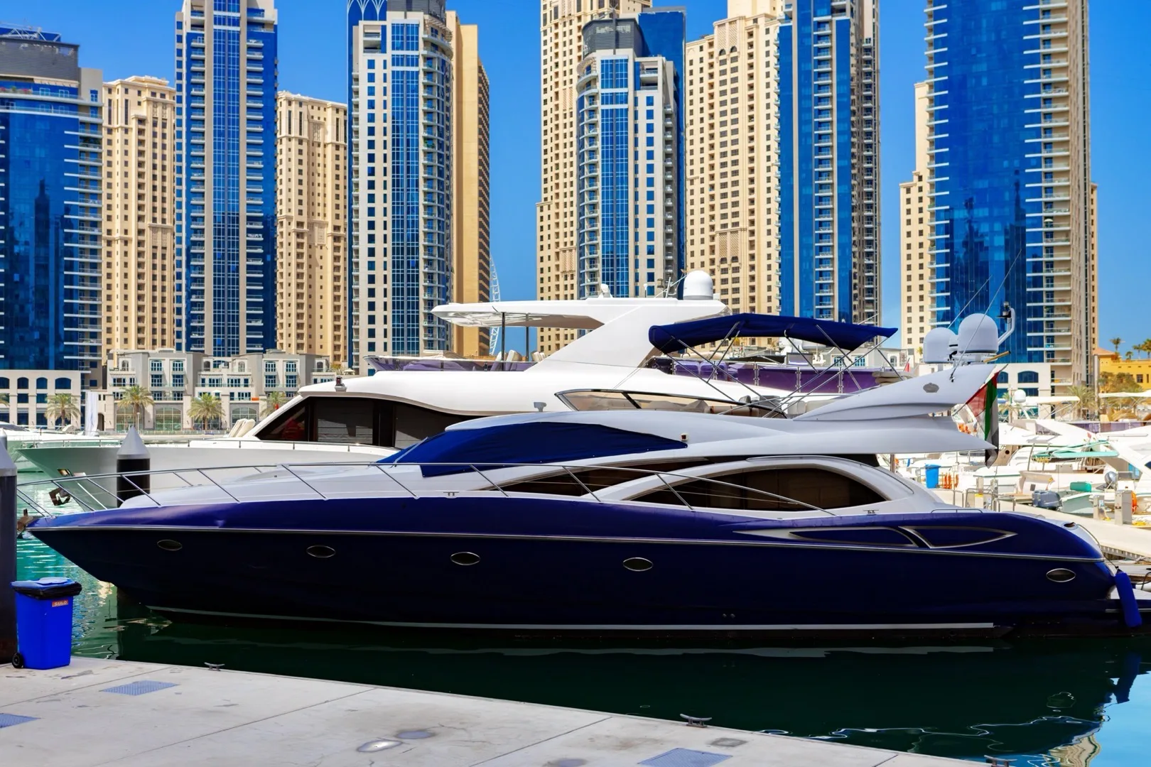 Dubai Harbour superyacht marina with mega-yachts and the Palm Jumeirah in the background