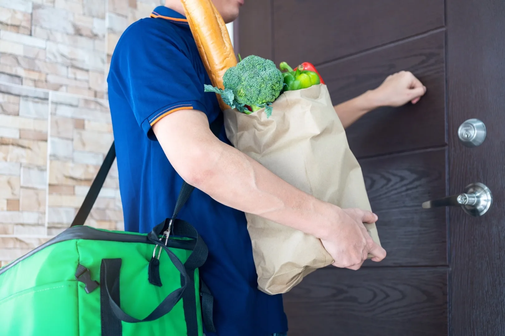 Grocery delivery bags at a Dubai apartment door