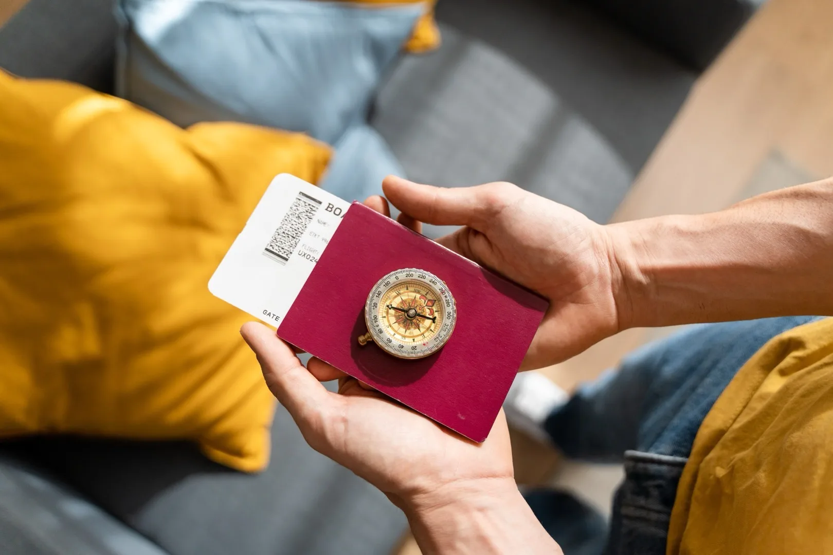 Passport with boarding pass and compass ready for travel